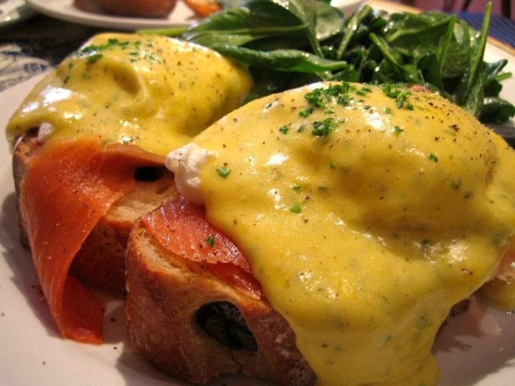 A close up of a plate of food with eggs benedict