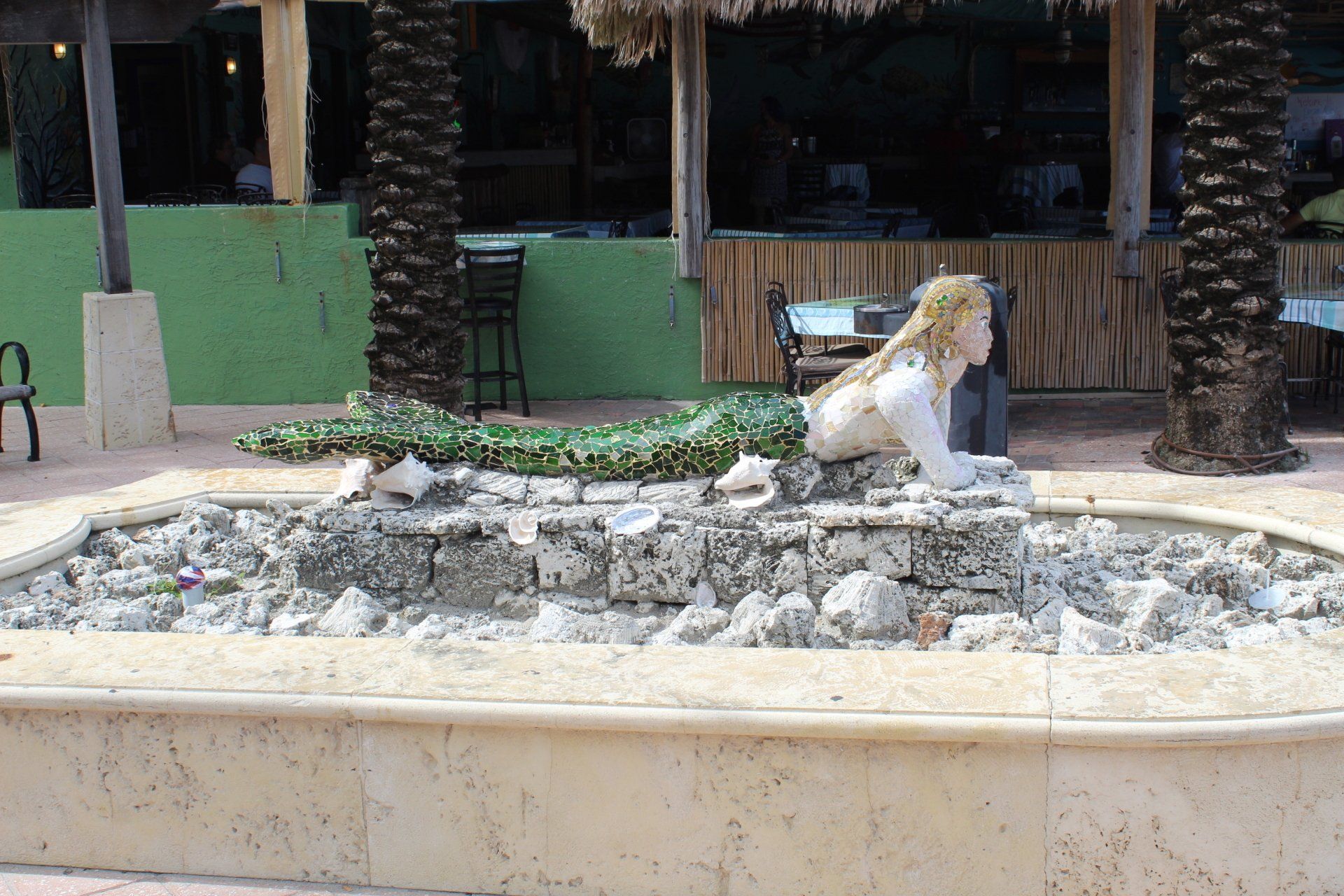 A fountain with a statue of a mermaid in it