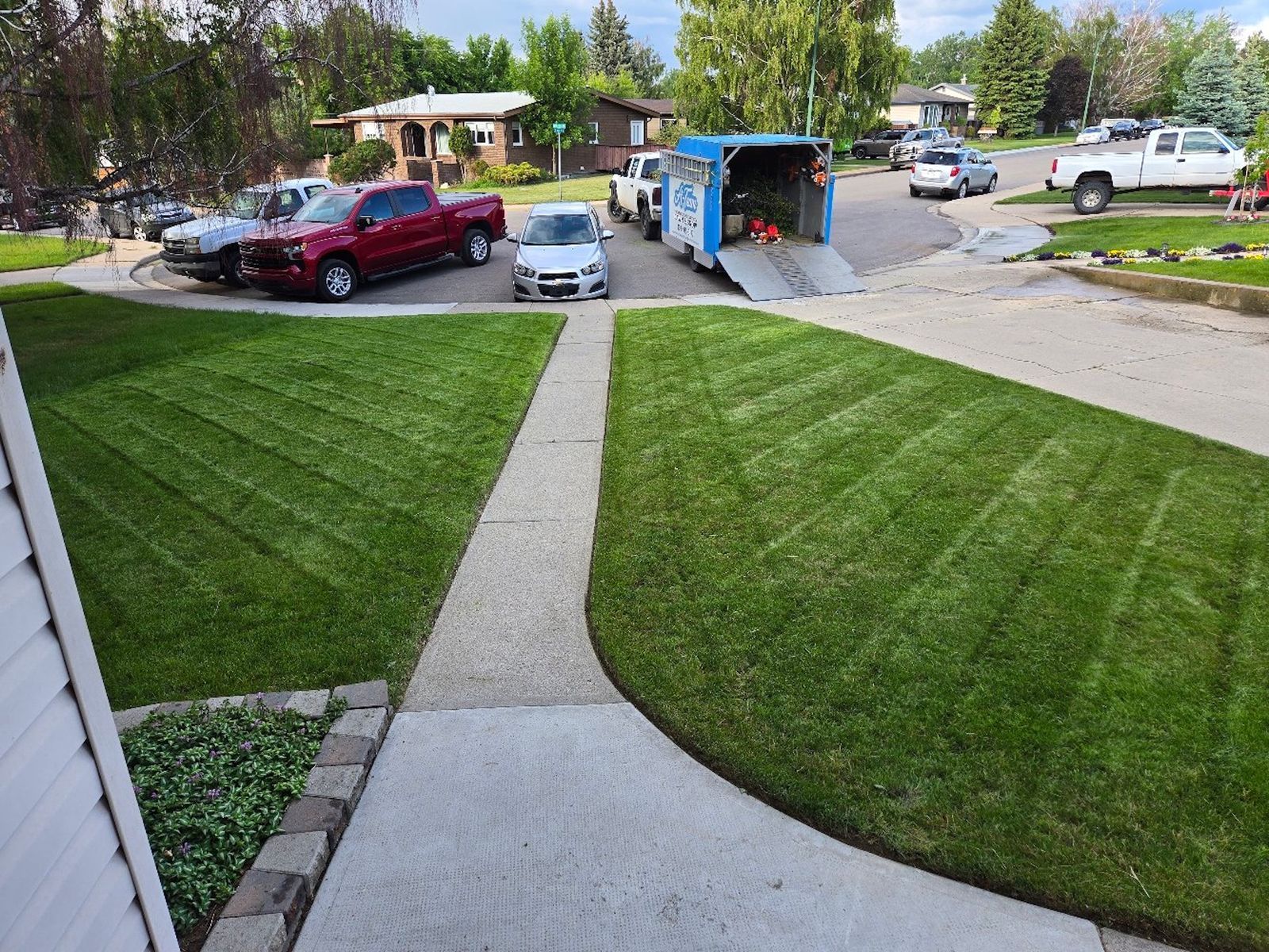A manicured lawn with chevron-patterned mowing lines.