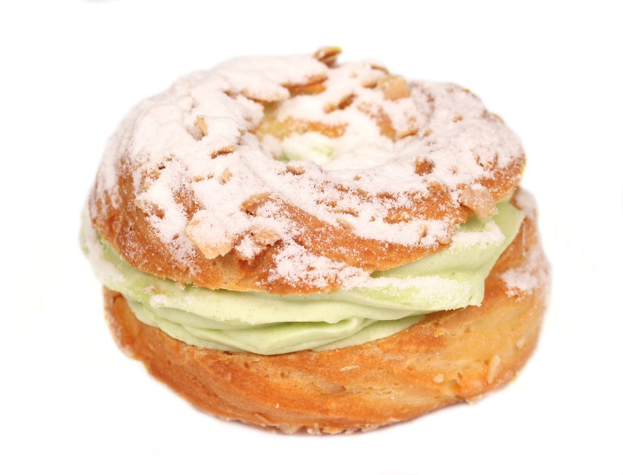 Cream puff with green filling, dusted with powdered sugar.