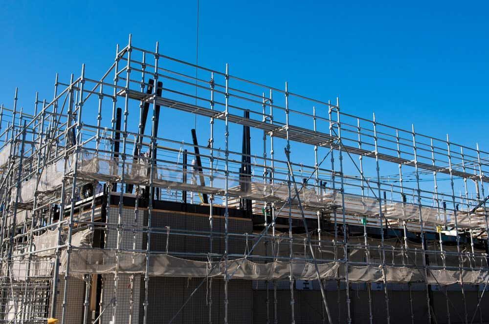 A Building Is Being Built With Scaffolding And A Blue Sky In The Background — Triple S Scaffolding In Port Macquarie, NSW
