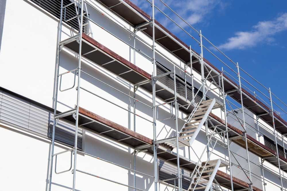 A Building With Scaffolding And Stairs On The Side Of It — Triple S Scaffolding In Wauchope, NSW