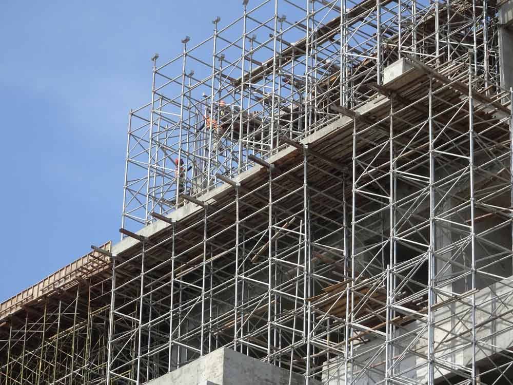 A Building Under Construction With Scaffolding On The Side Of It — Triple S Scaffolding In Port Macquarie, NSW