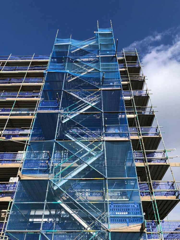A Tall Building Is Being Built With Scaffolding And Stairs — Triple S Scaffolding In Port Macquarie, NSW