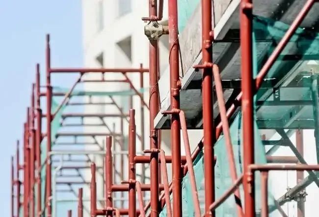 Red scaffolding at a building site— Triple S Scaffolding In Port Macquarie, NSW