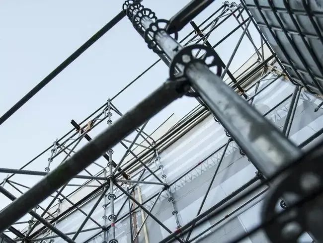Looking Up At A Building With Scaffolding On It — Triple S Scaffolding In Port Macquarie, NSW