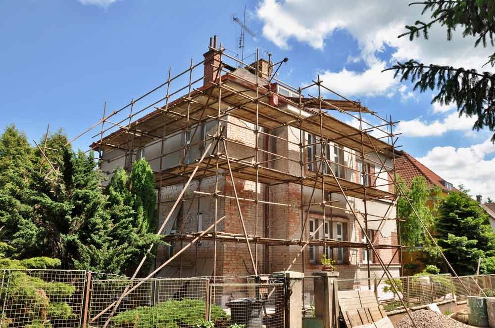A House Is Being Remodelled With Scaffolding Around It — Triple S Scaffolding In Wauchope, NSW