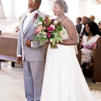 Bride walks down the aisle with her father at a wedding ceremony.