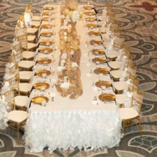 Formal banquet table set for a wedding. Gold accents and white linens.