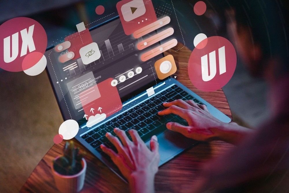 Person using a laptop, designing an interface with