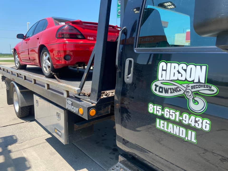 Transporting Red Sedan — Leland, IL — Gibson Towing