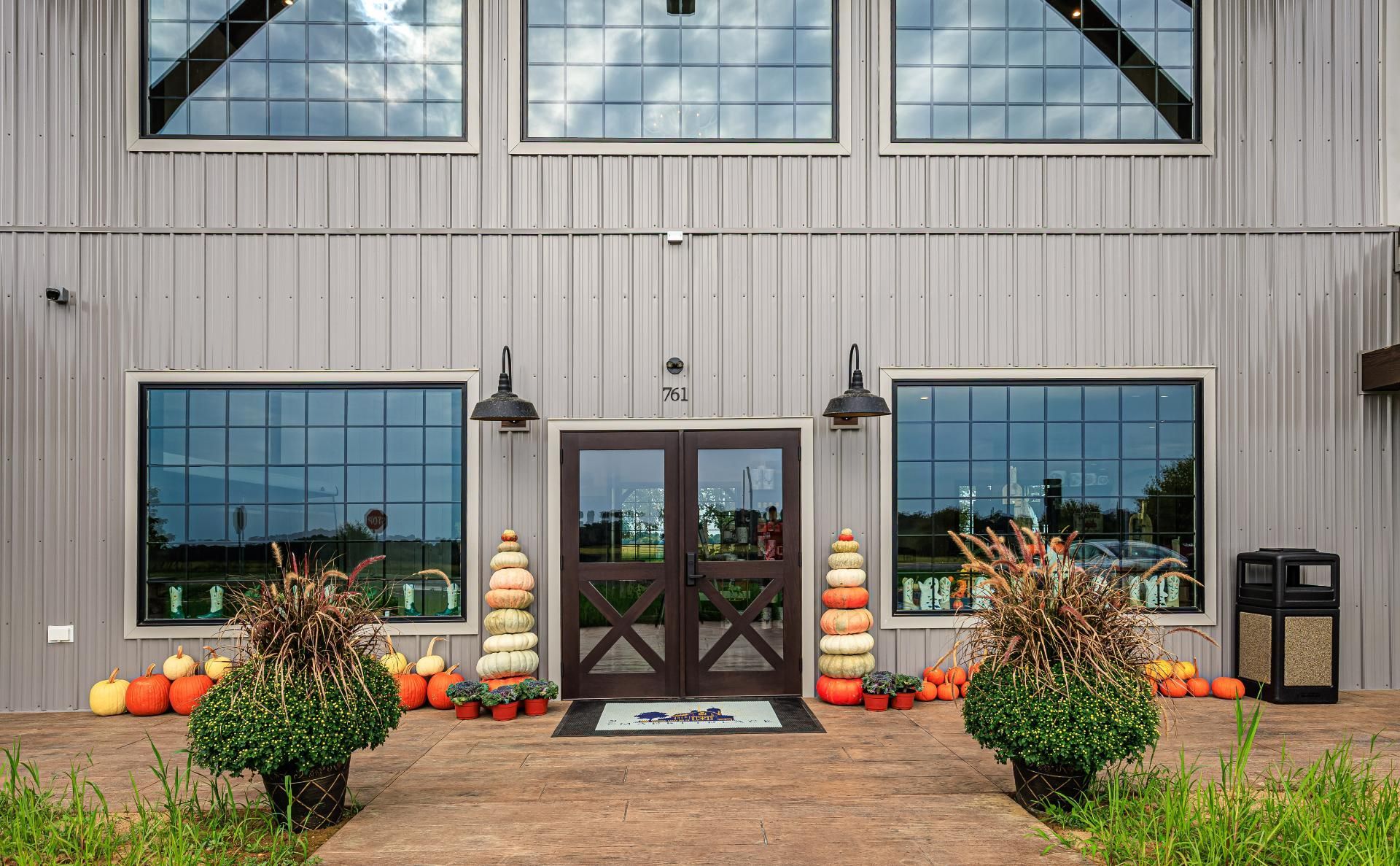 Close up of Bullhide Brewery main entrance showing window treatments and metal siding of the exterior 
