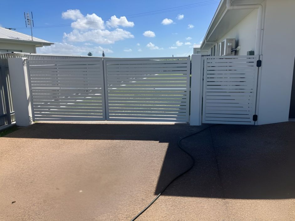 A White Fence is Sitting in Front of a White House — Gate-O-Matic In Kelso, QLD