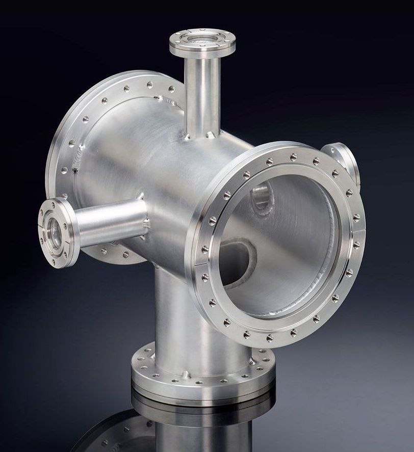 A metal cube with two holes in it