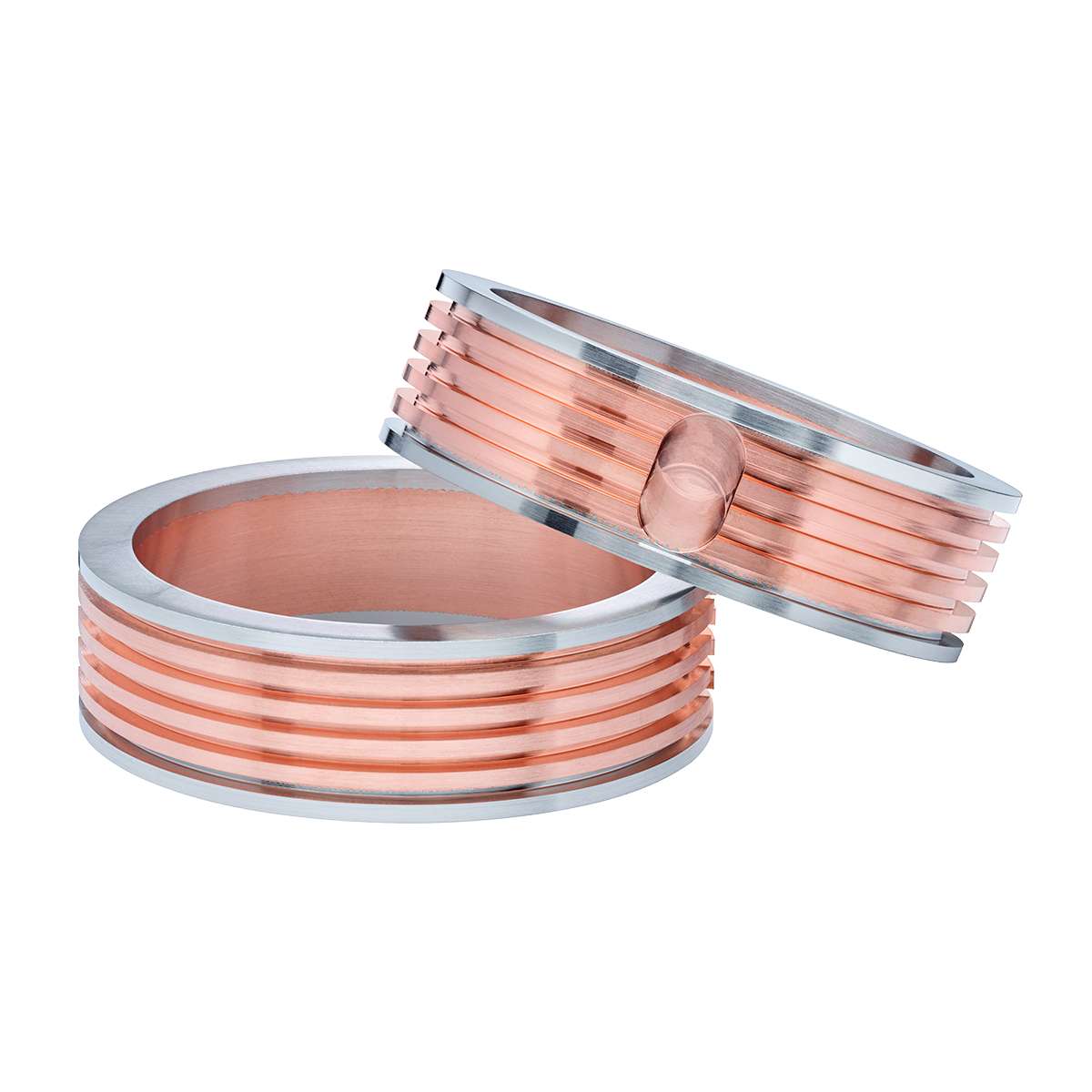 A pair of copper and silver wedding rings on a white background