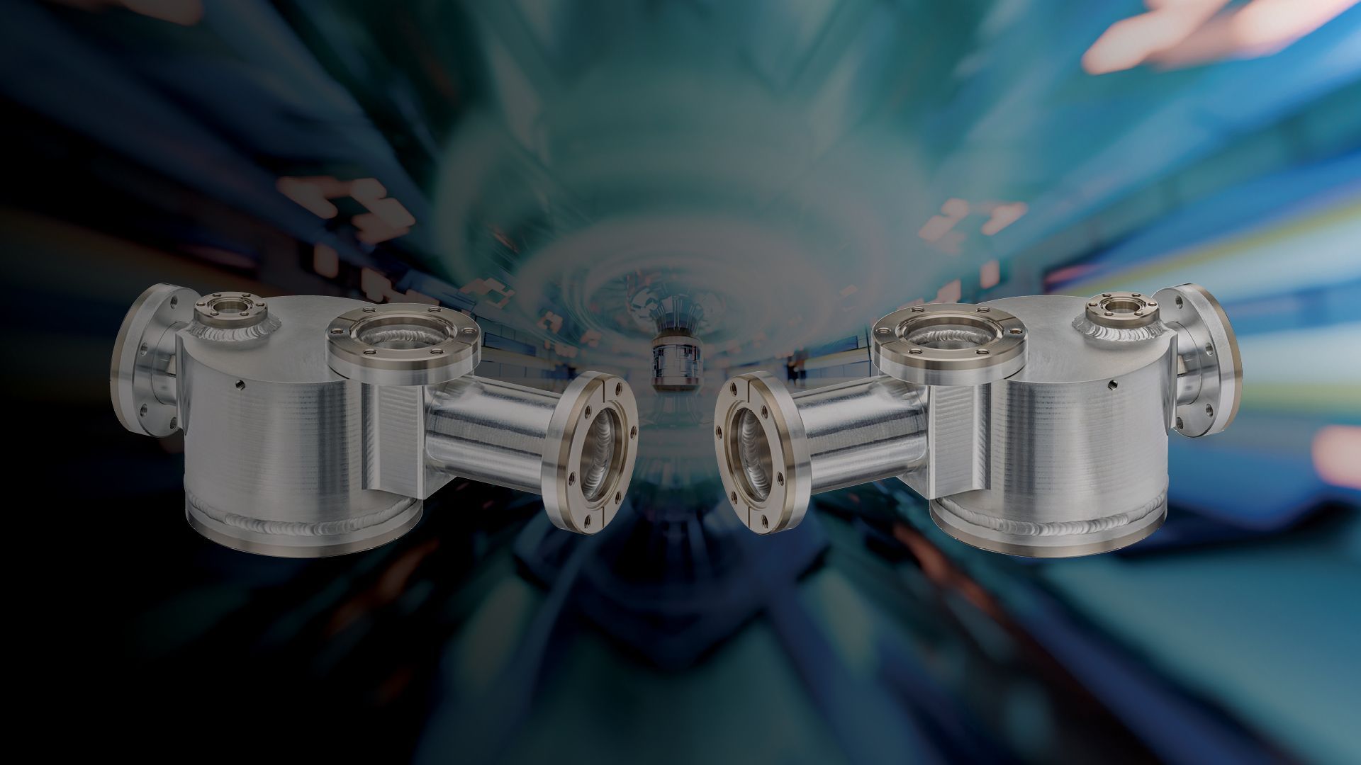 Two aluminum vacuum chambers with titanium flanges shown in front of a simulated particle accelerator background.