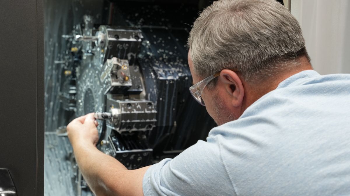 A man is working on a machine in a factory.