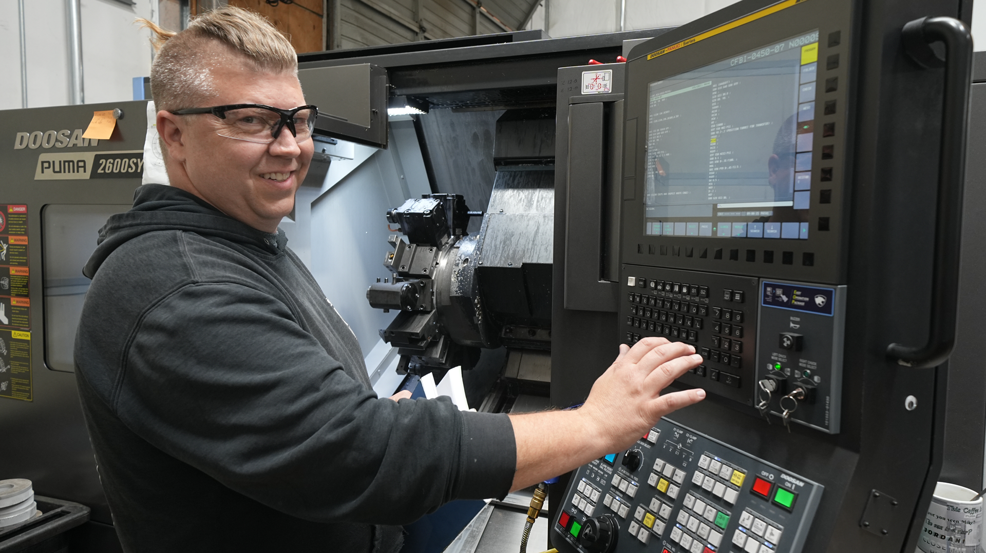 A man is working on a machine in a factory.