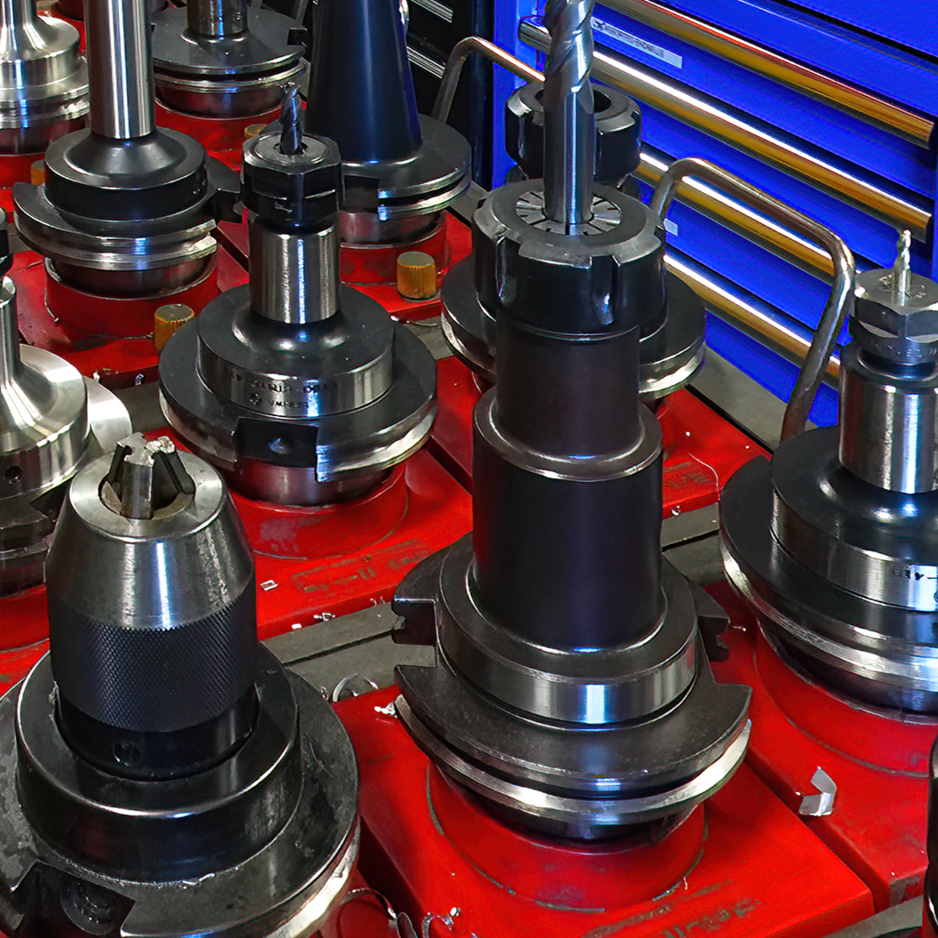 A bunch of metal parts are sitting on a red table