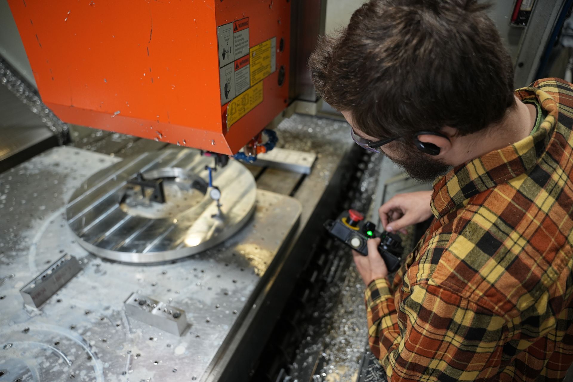 A man is working on a machine in a factory.