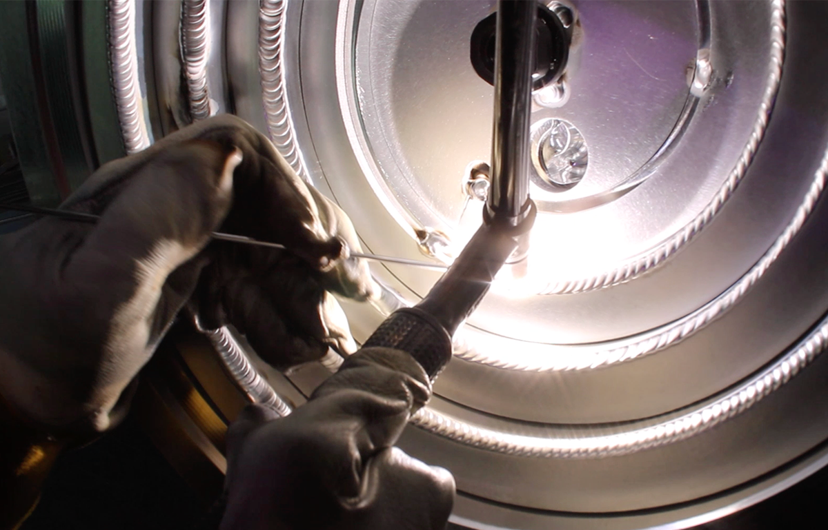 A close up of a person welding a metal object