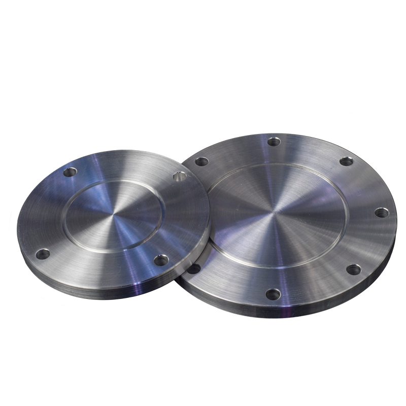 Two stainless steel flanges are sitting next to each other on a white surface.