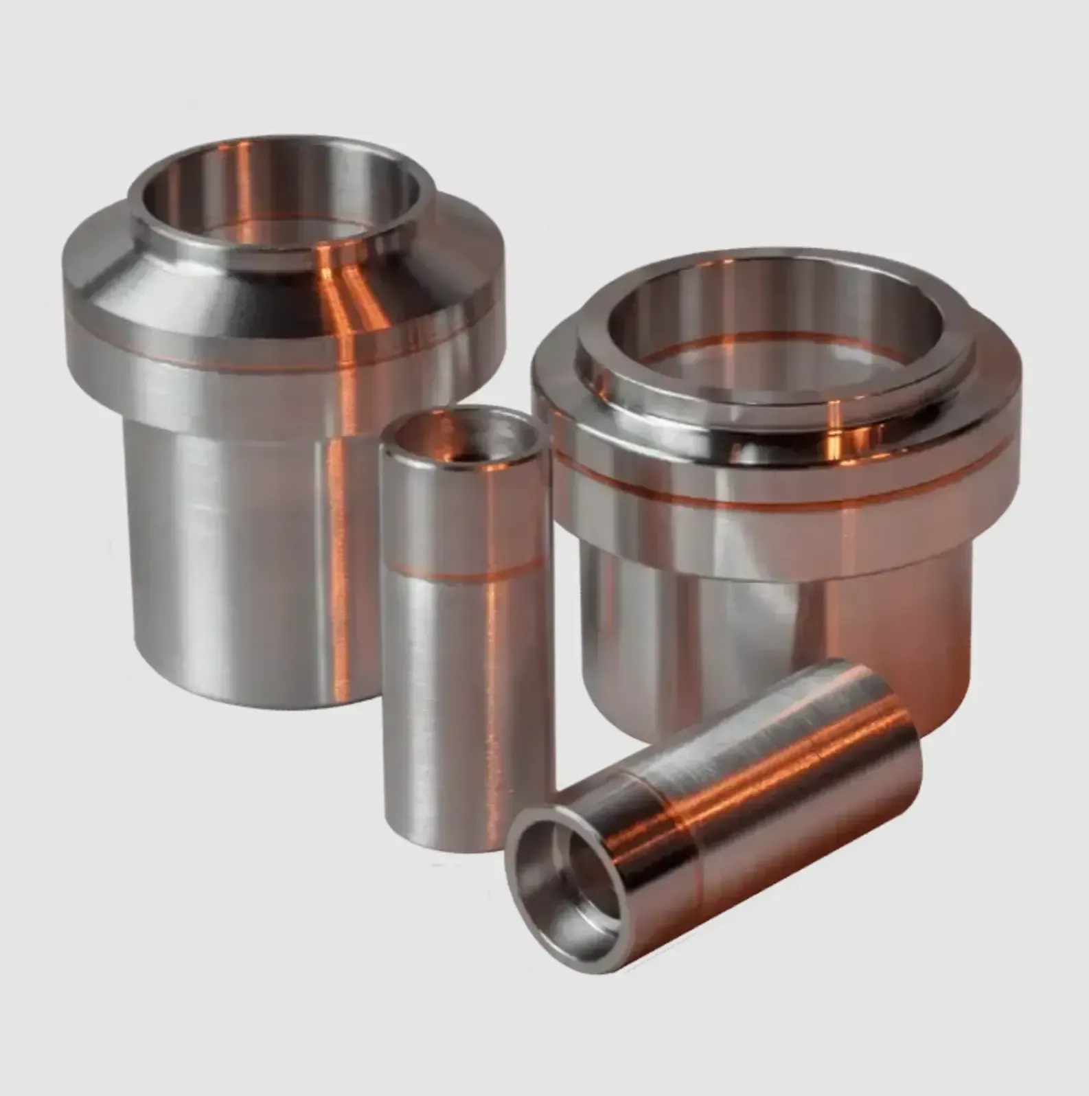 A group of stainless steel cylinders are stacked on top of each other