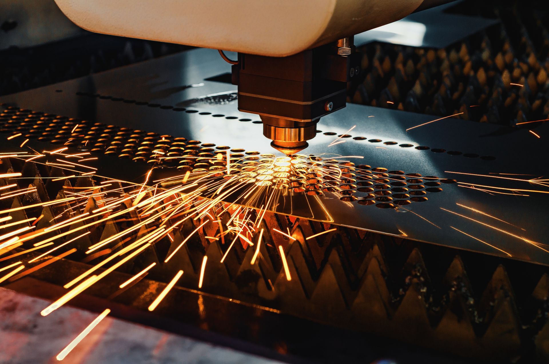 A close-up of a high-precision CNC laser cutting metal sheet. A close-up of a high-precision CNC laser cutting metal sheet.