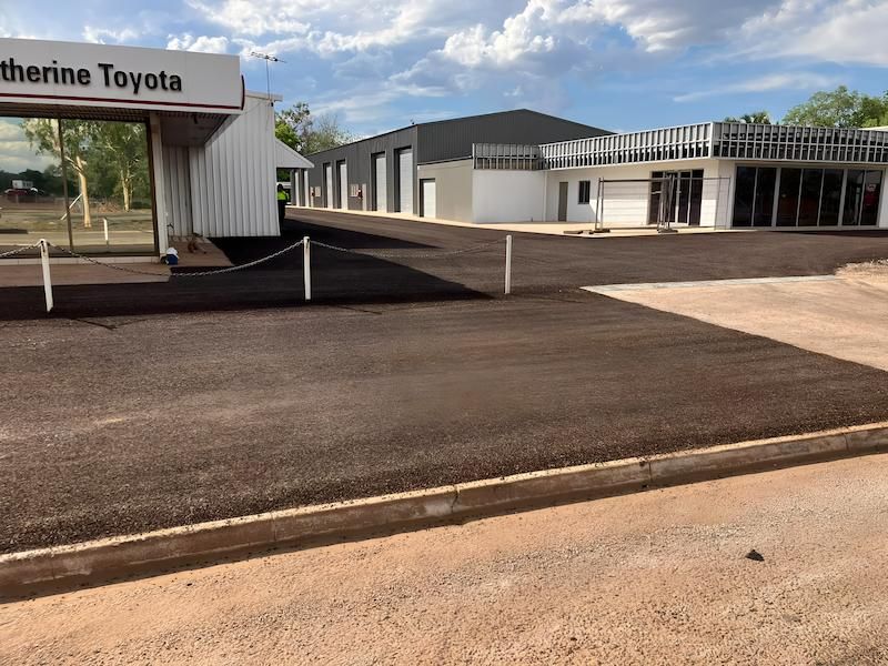 A Building With a Sign That Says Katherine Toyota with New Asphalt— F & J Bitumen Services in Humpty Doo, NT