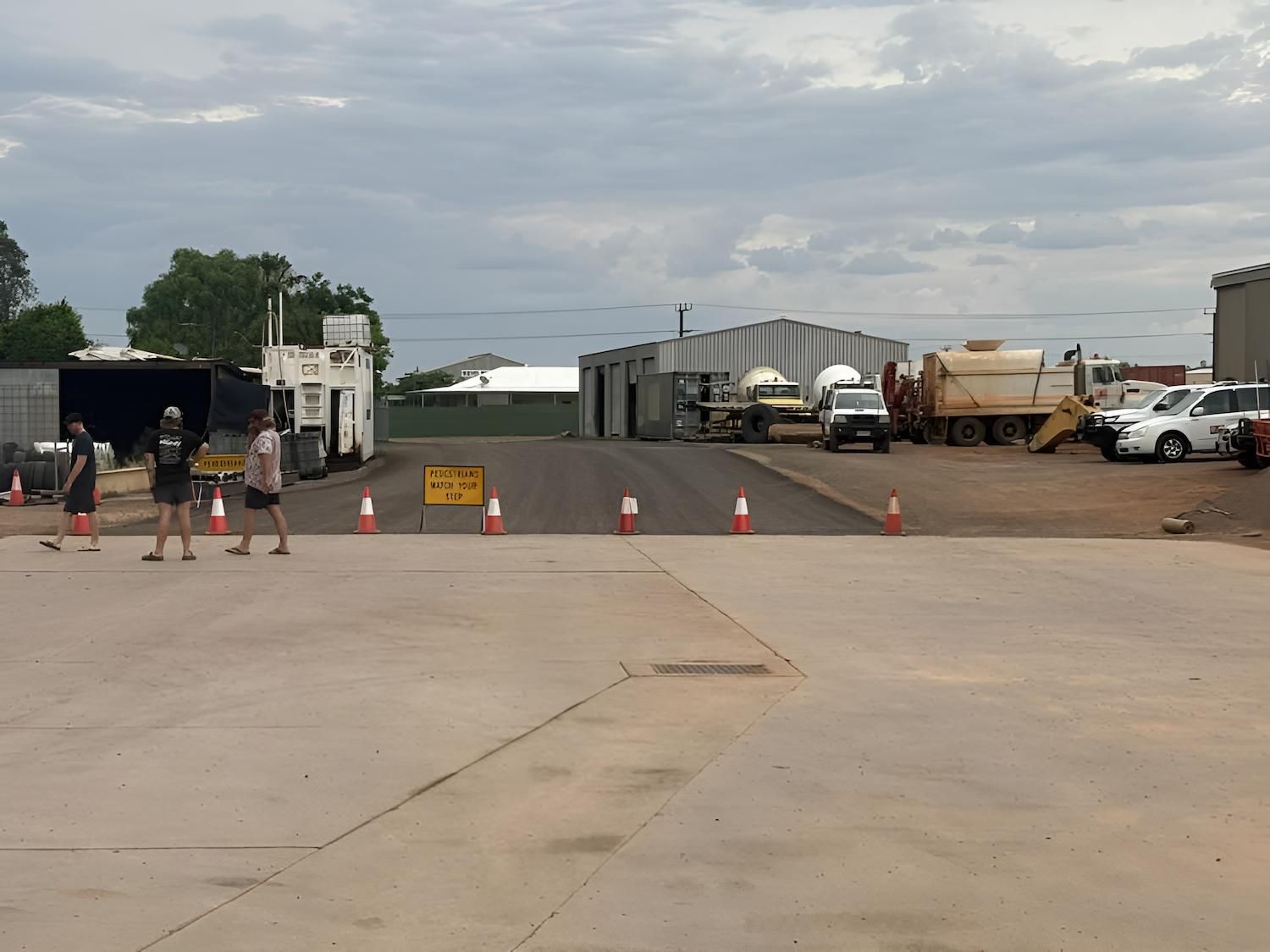 A Group of People Are Standing Beside the Asphalt — F & J Bitumen Services in Humpty Doo, NT