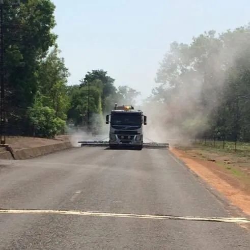 A Truck is Driving Down a Road With Smoke Coming Out of It — F & J Bitumen Services in Humpty Doo, NT