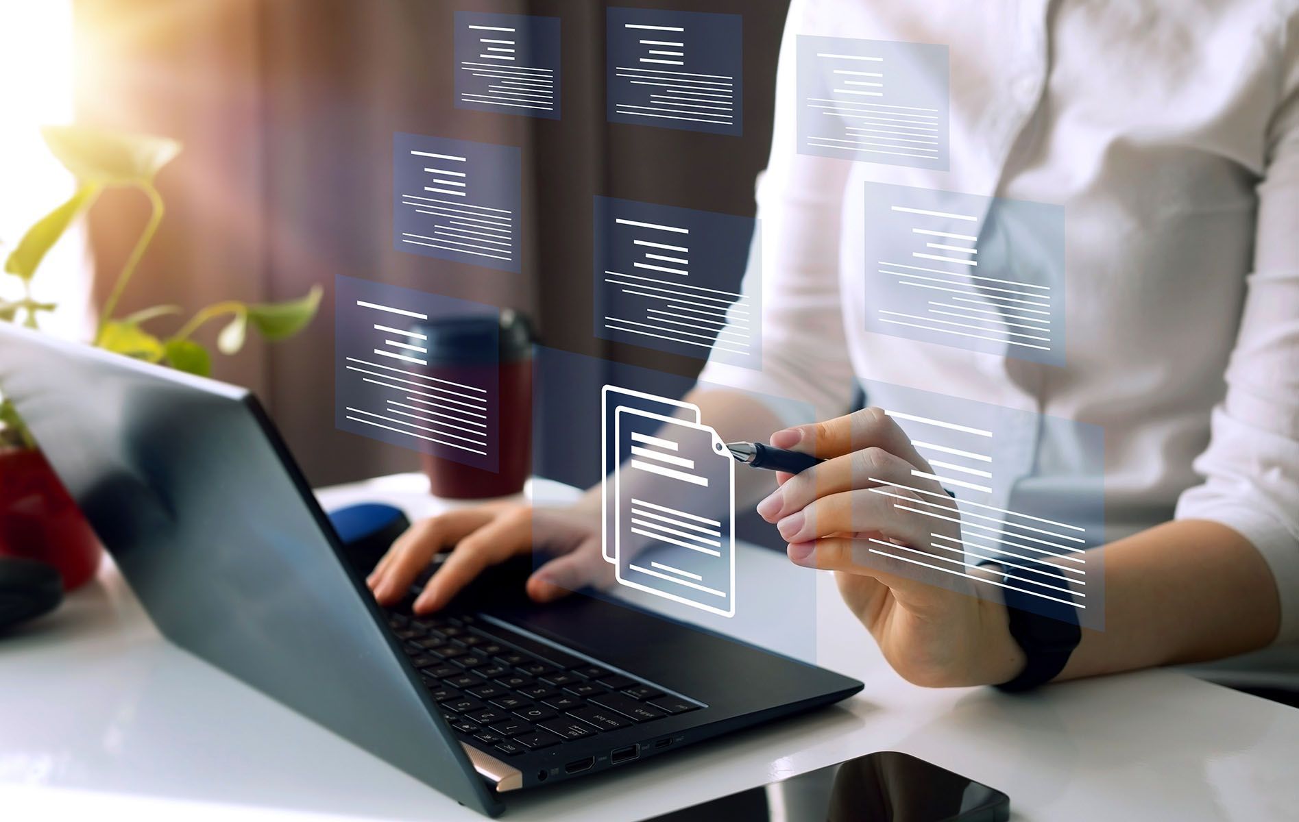 Close up of woman using a laptop touching a virtual digital screen