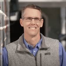 Photo of Randy Feenstra, a smiling white man in glasses wearing a gray sport jacket and light blue shirt