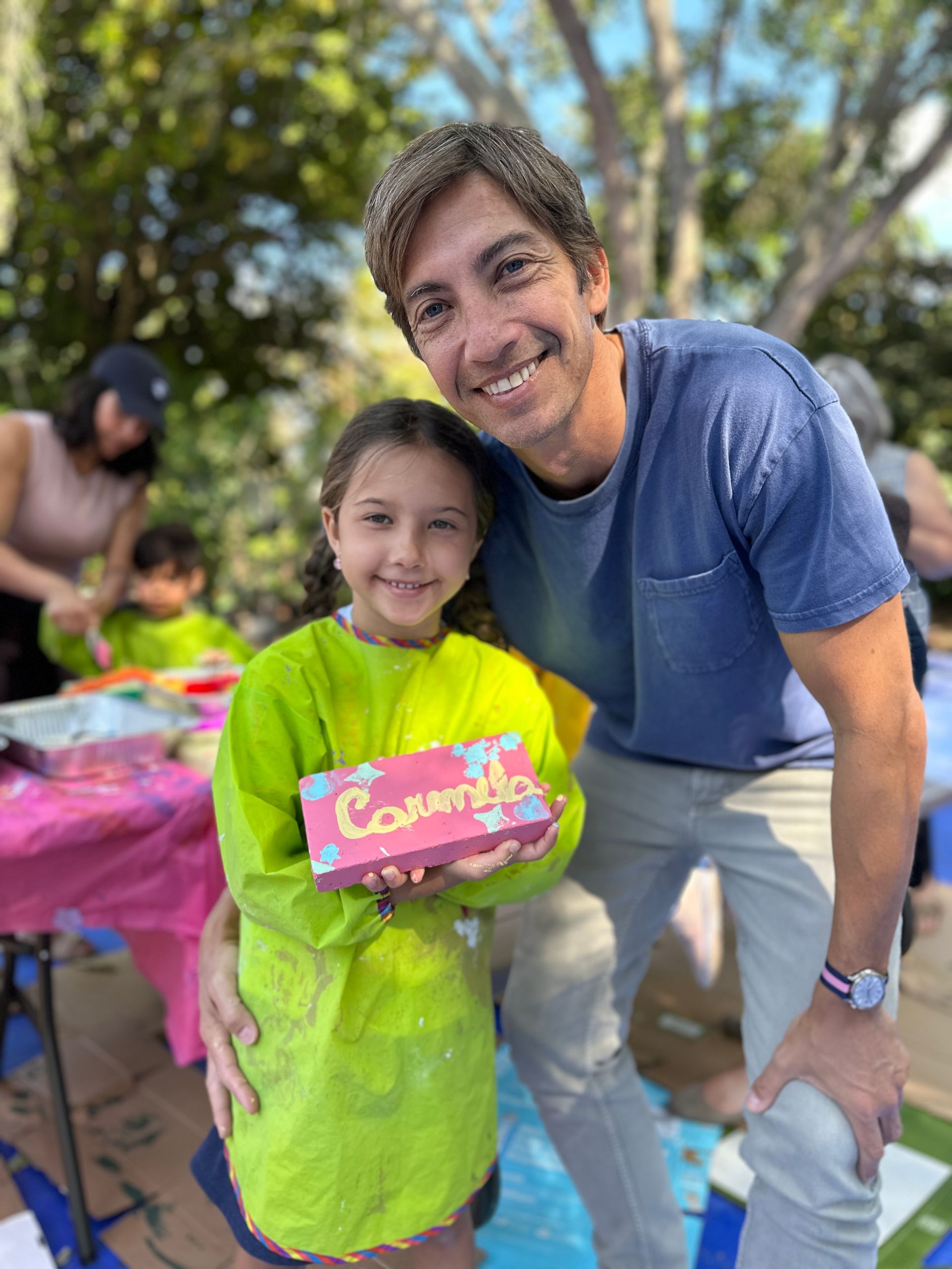 A man and a Montessori child are posing for a picture.