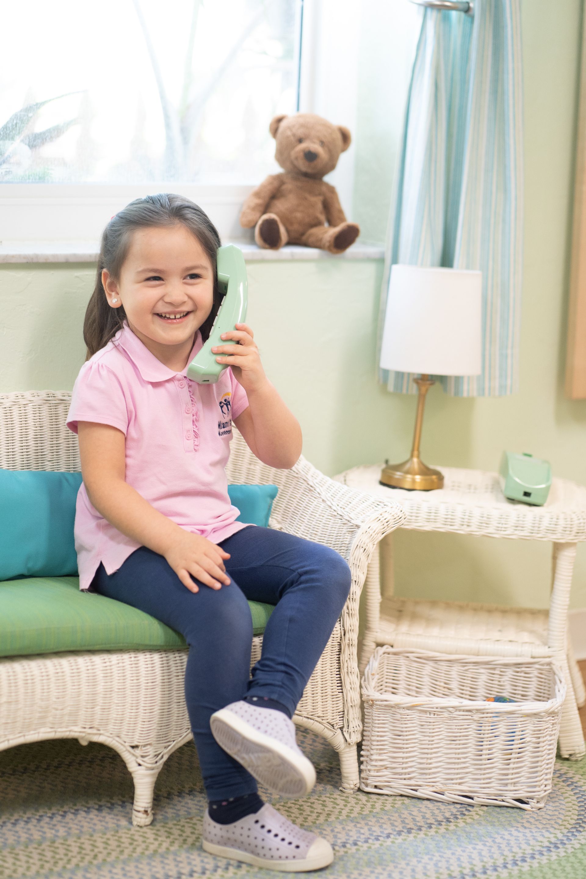Montessori child holding a telephone