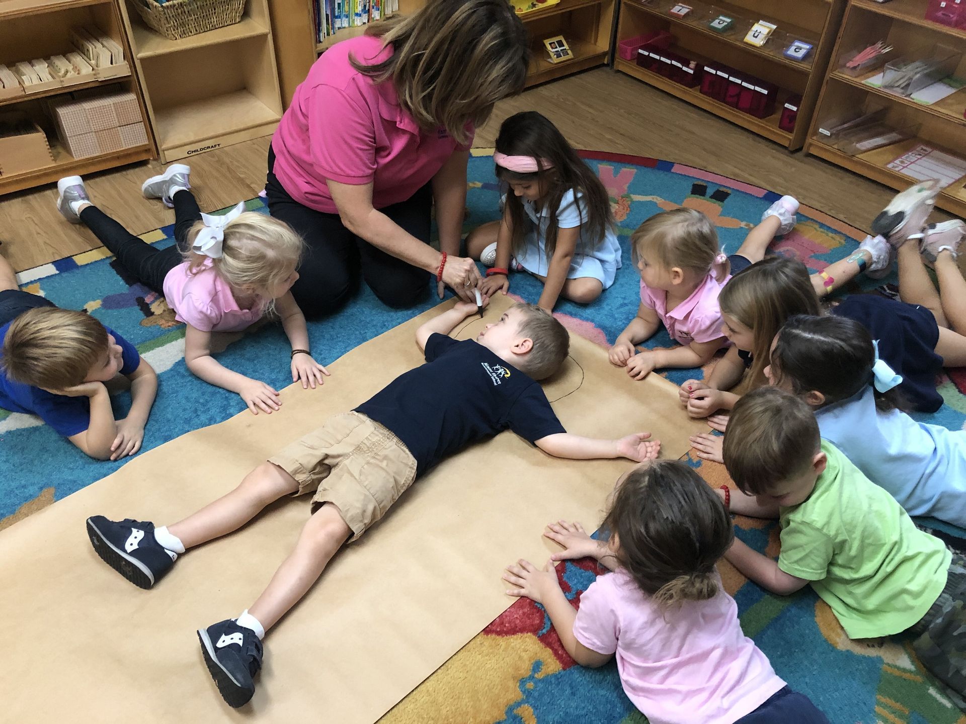 Montessori children and guide in a lesson activity