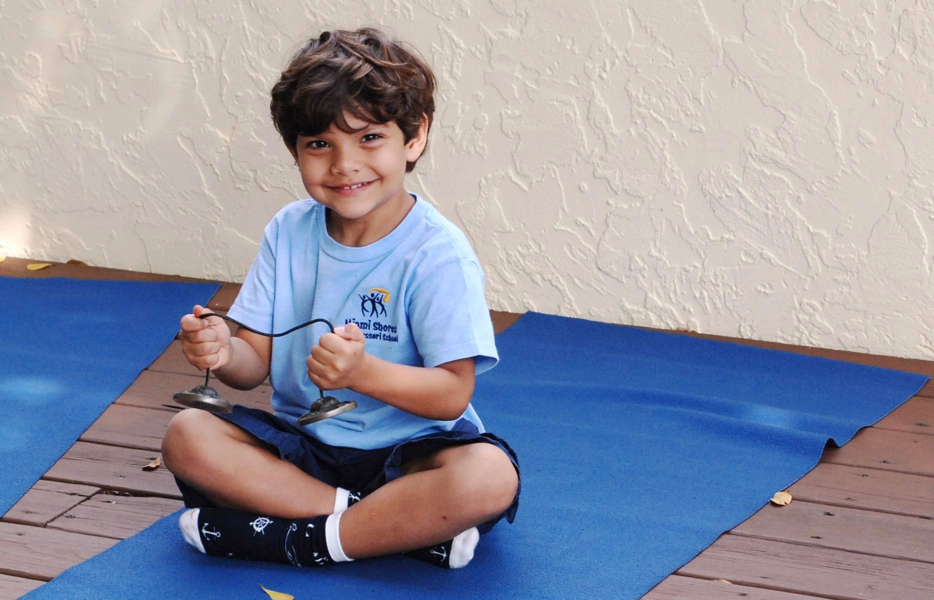 Montessori child on a yoga mat