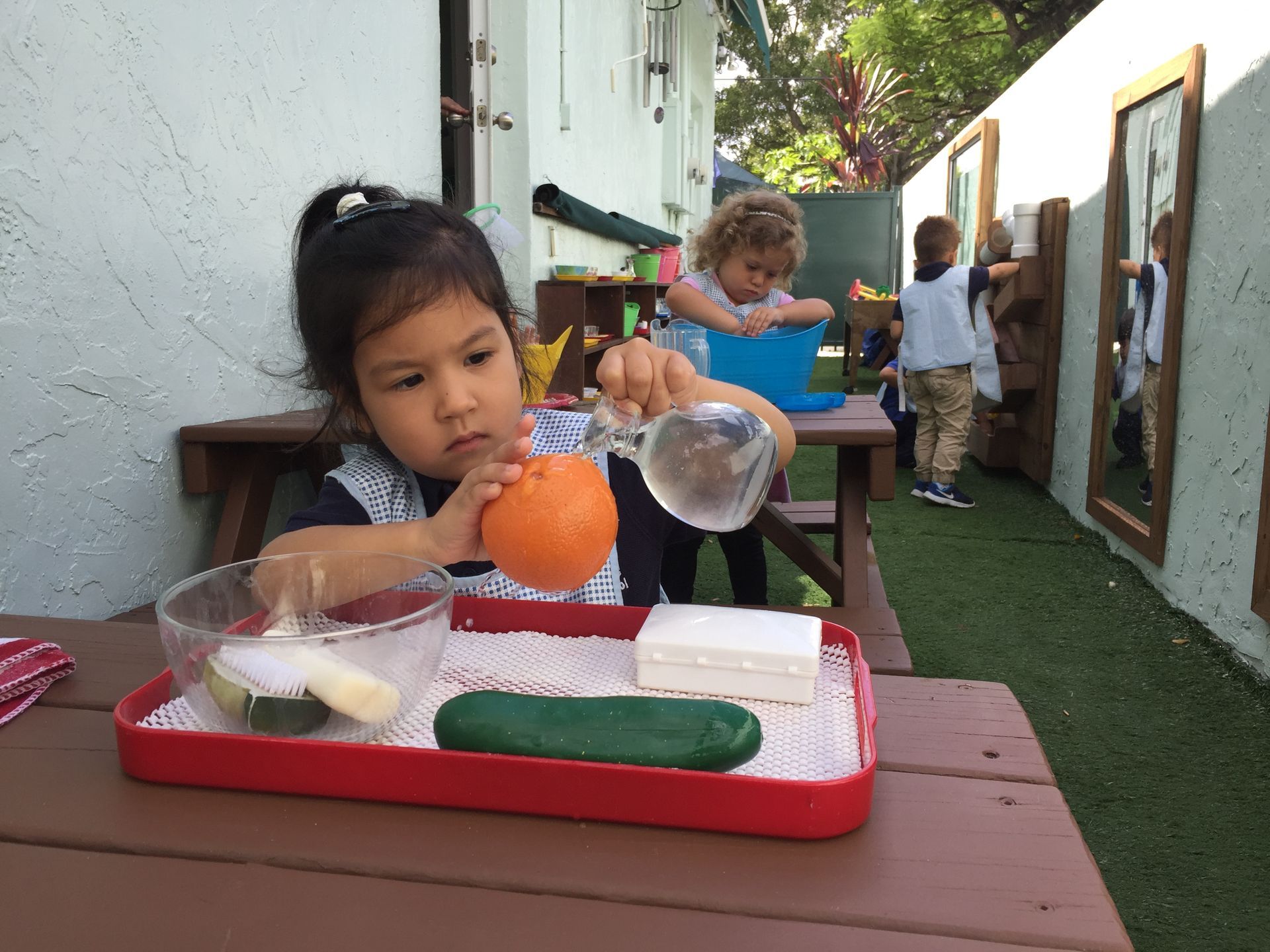 Montessori toddler working on practical life skills