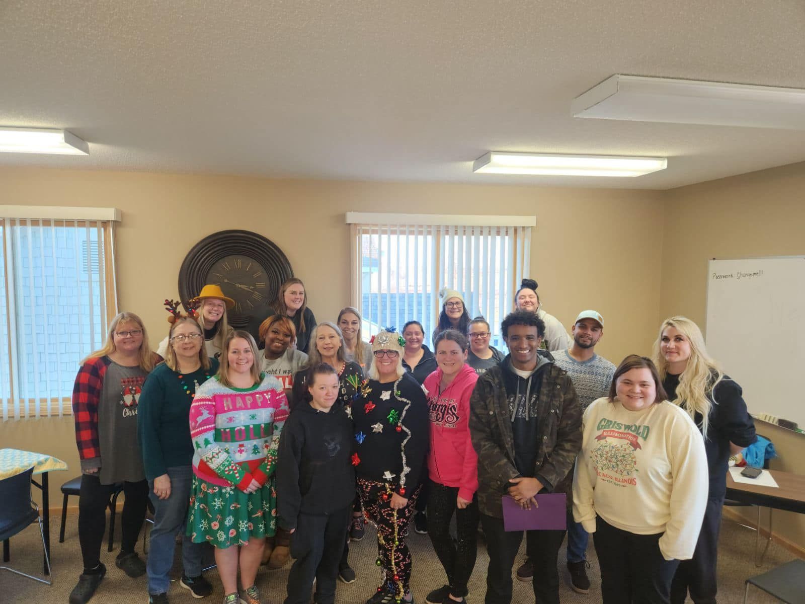 A group of people are posing for a picture in a room.
