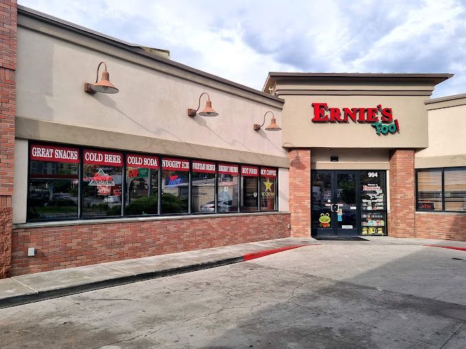 Exterior of Ernie's convenience store with brick facade, beige walls, and red signage.