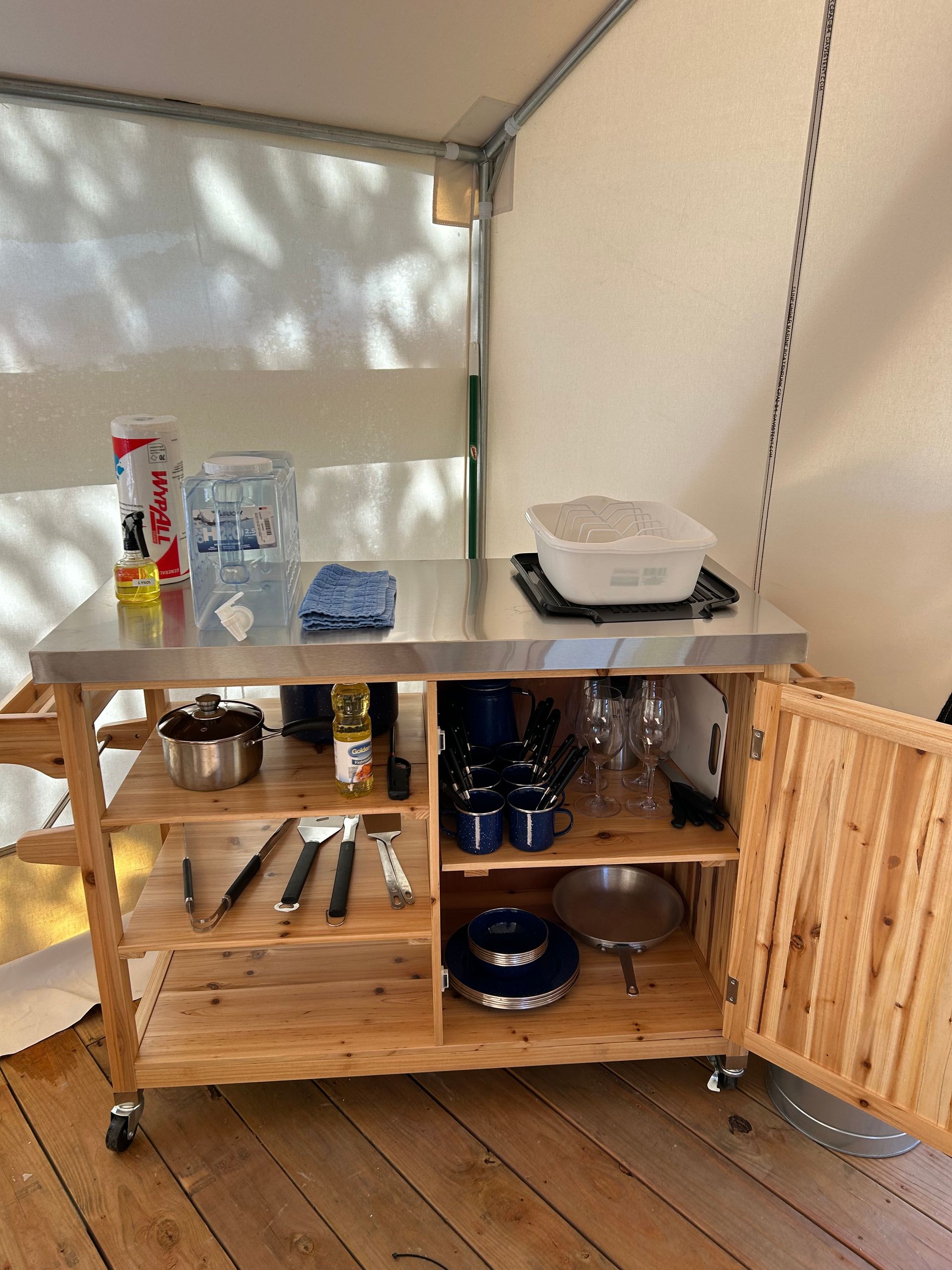 A wooden cabinet with a stainless steel counter top