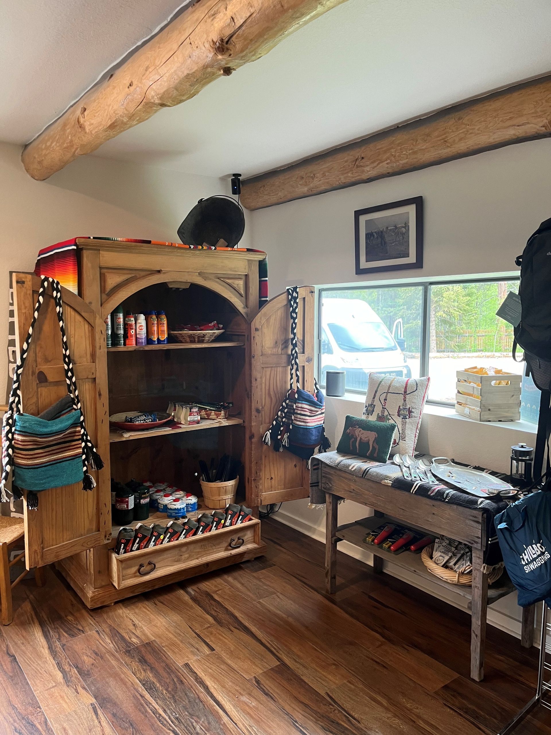 A room with a wooden cabinet and a wooden table.