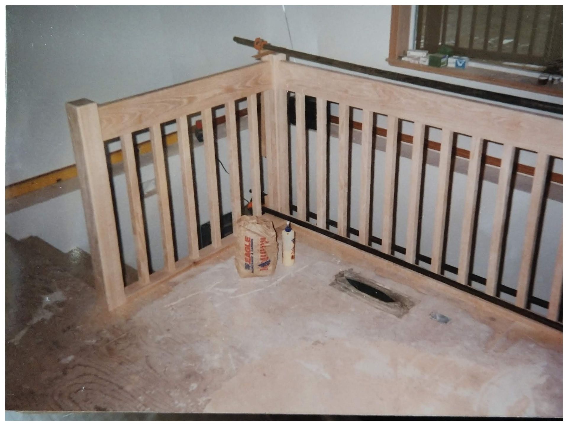 A wooden railing is being built in a room