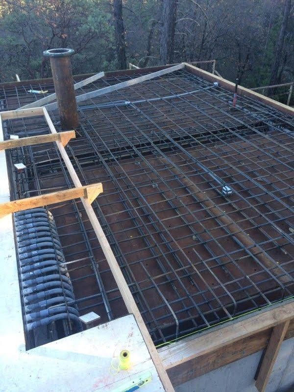 A roof is being built with a chimney in the background.