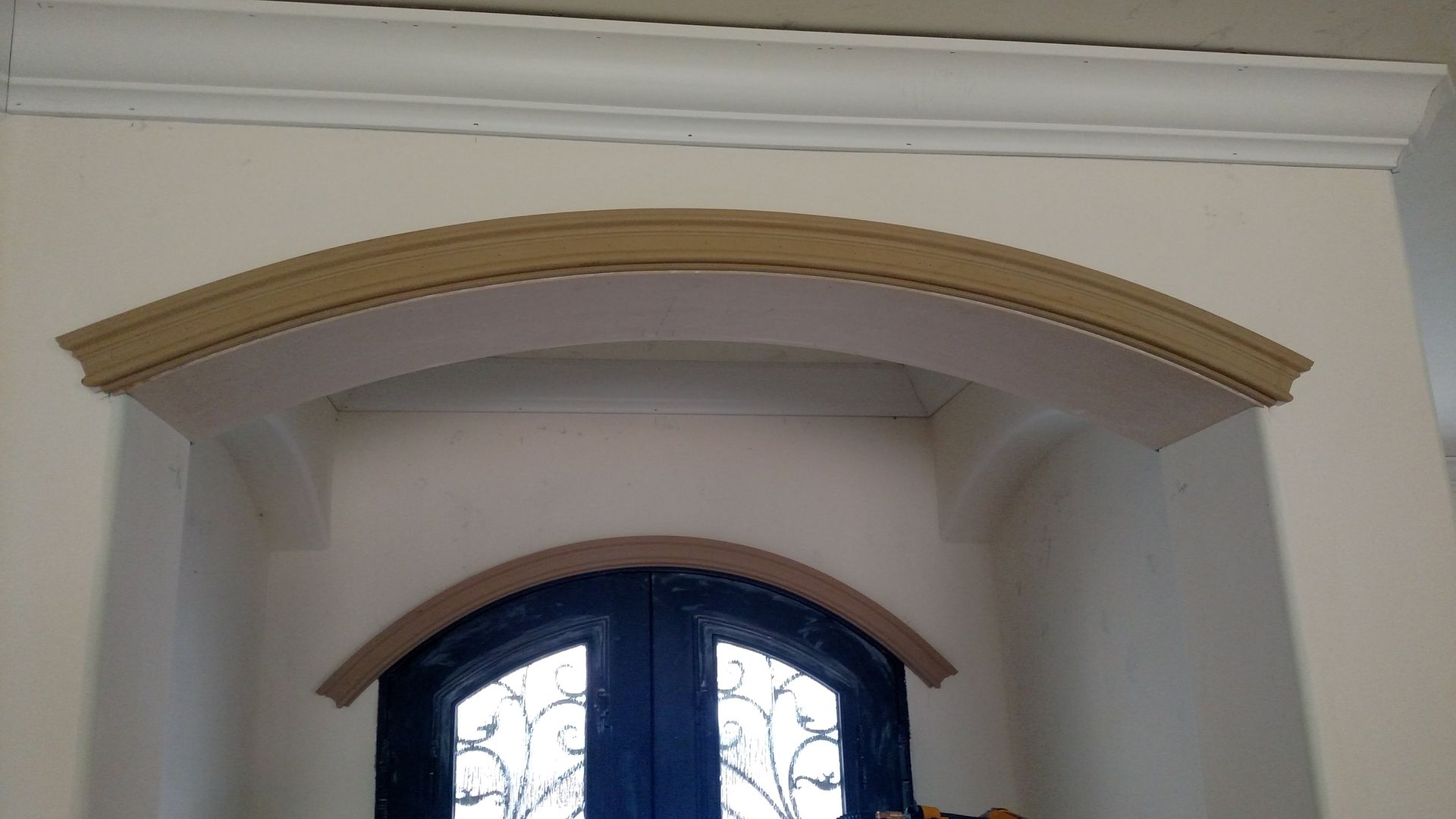 A blue door with a white arch above it