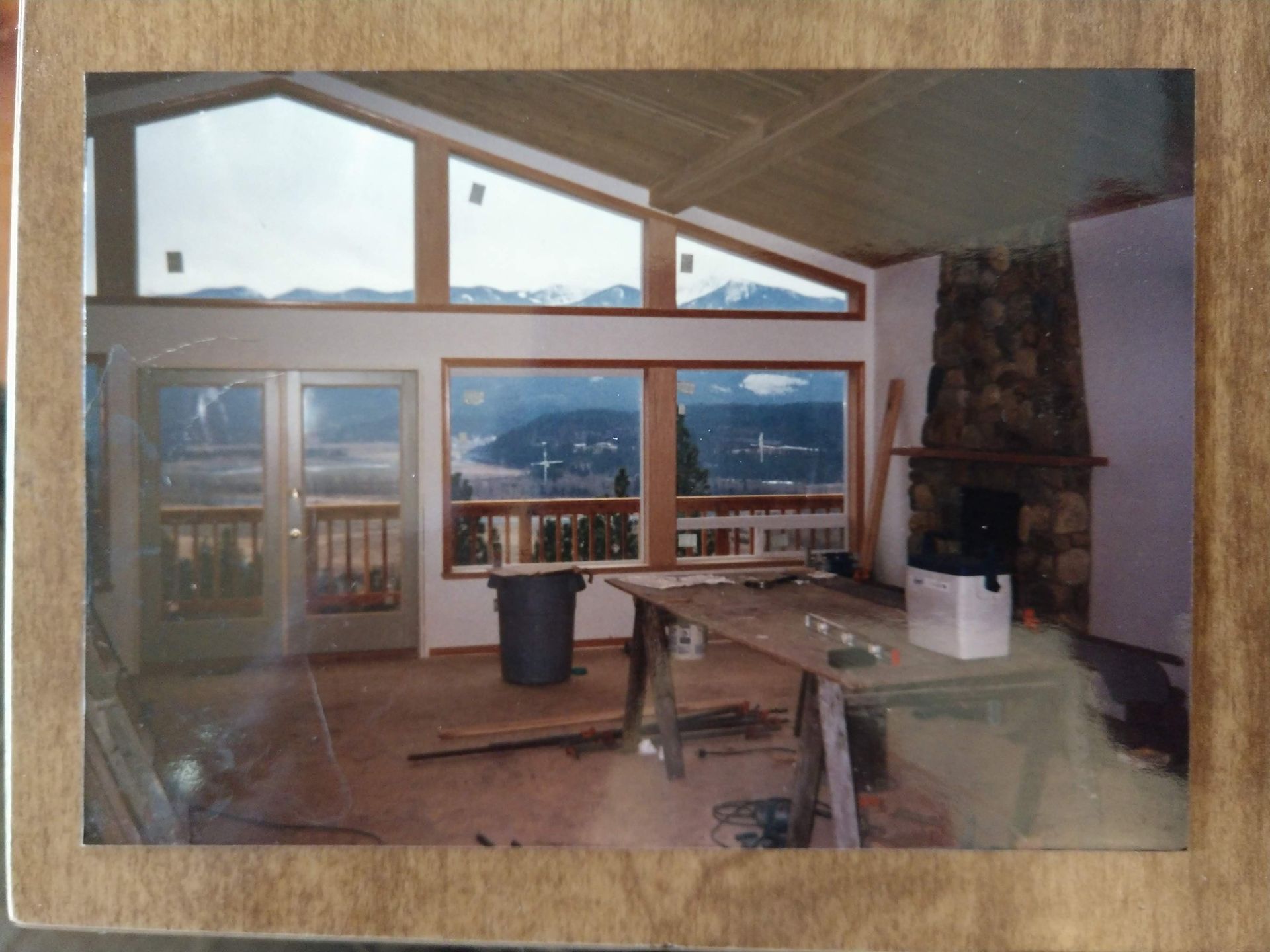 A picture of a house under construction with mountains in the background
