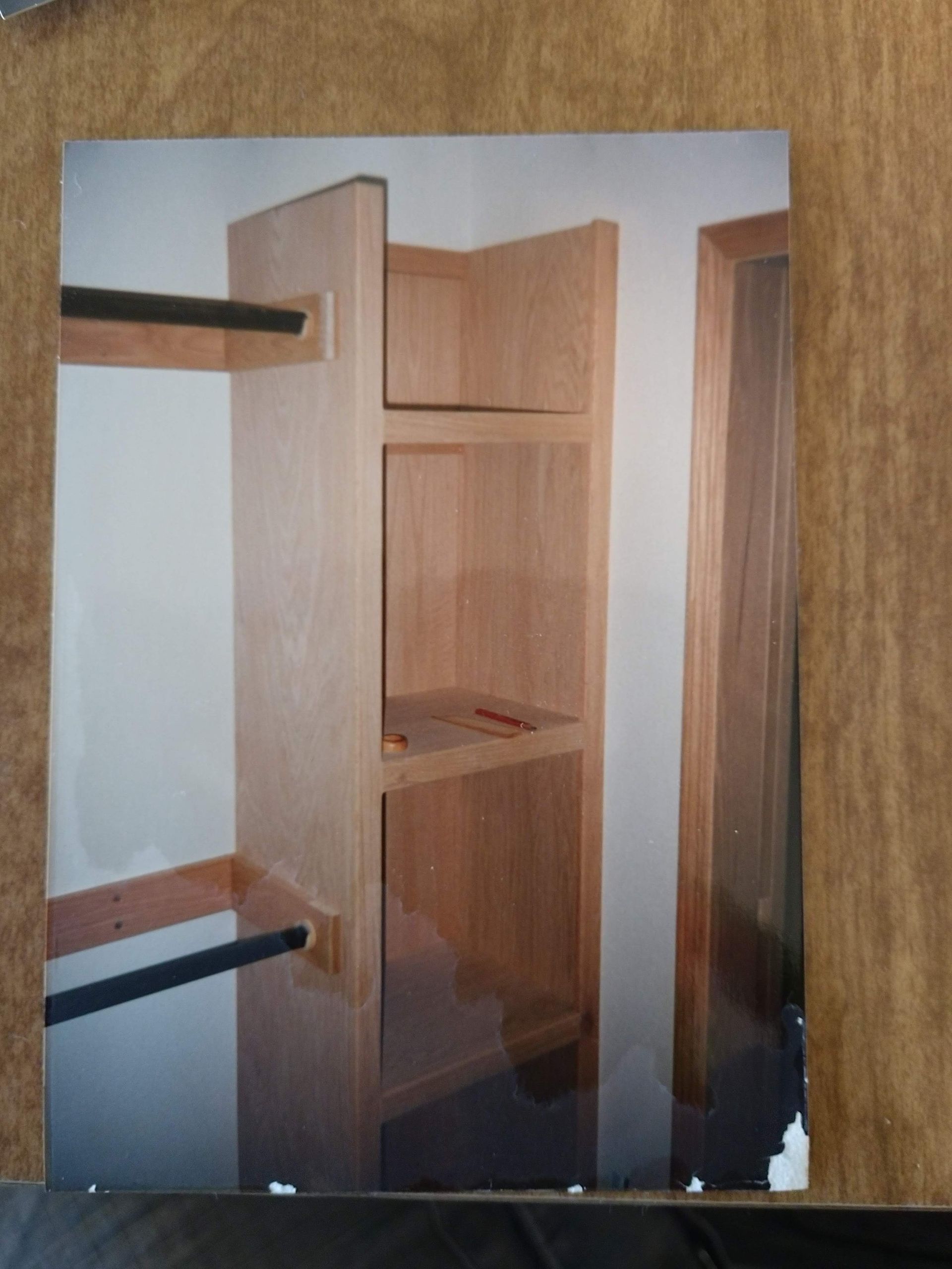 A picture of a closet with shelves and a door