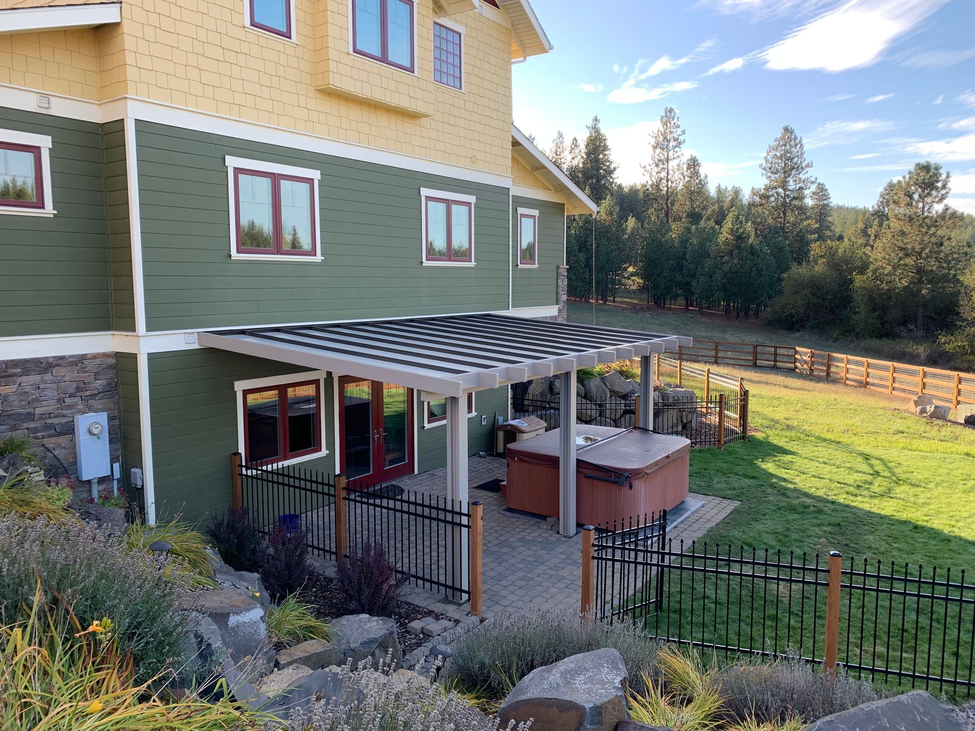 A large house with a hot tub in the backyard.