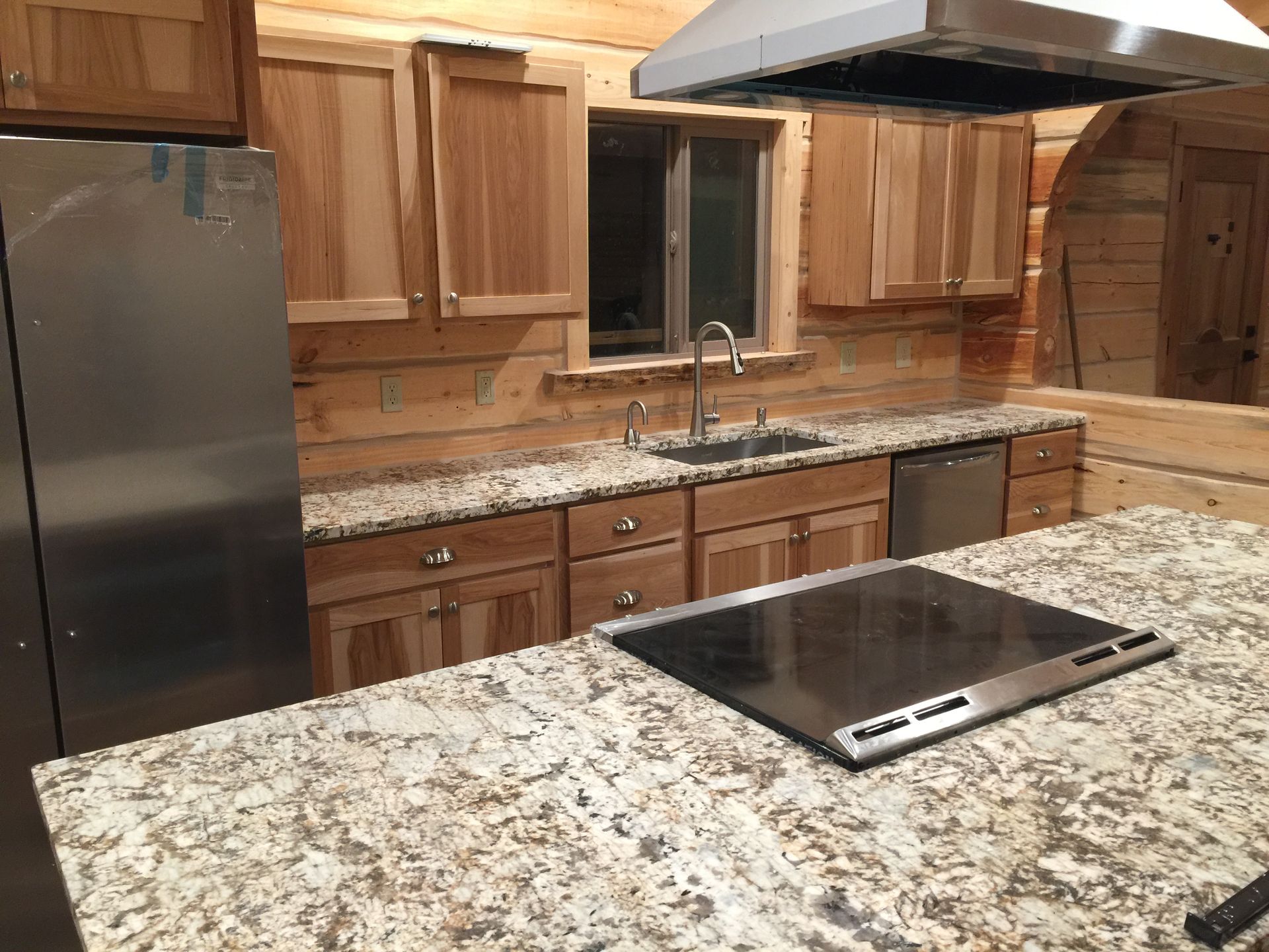 A kitchen with granite counter tops and stainless steel appliances