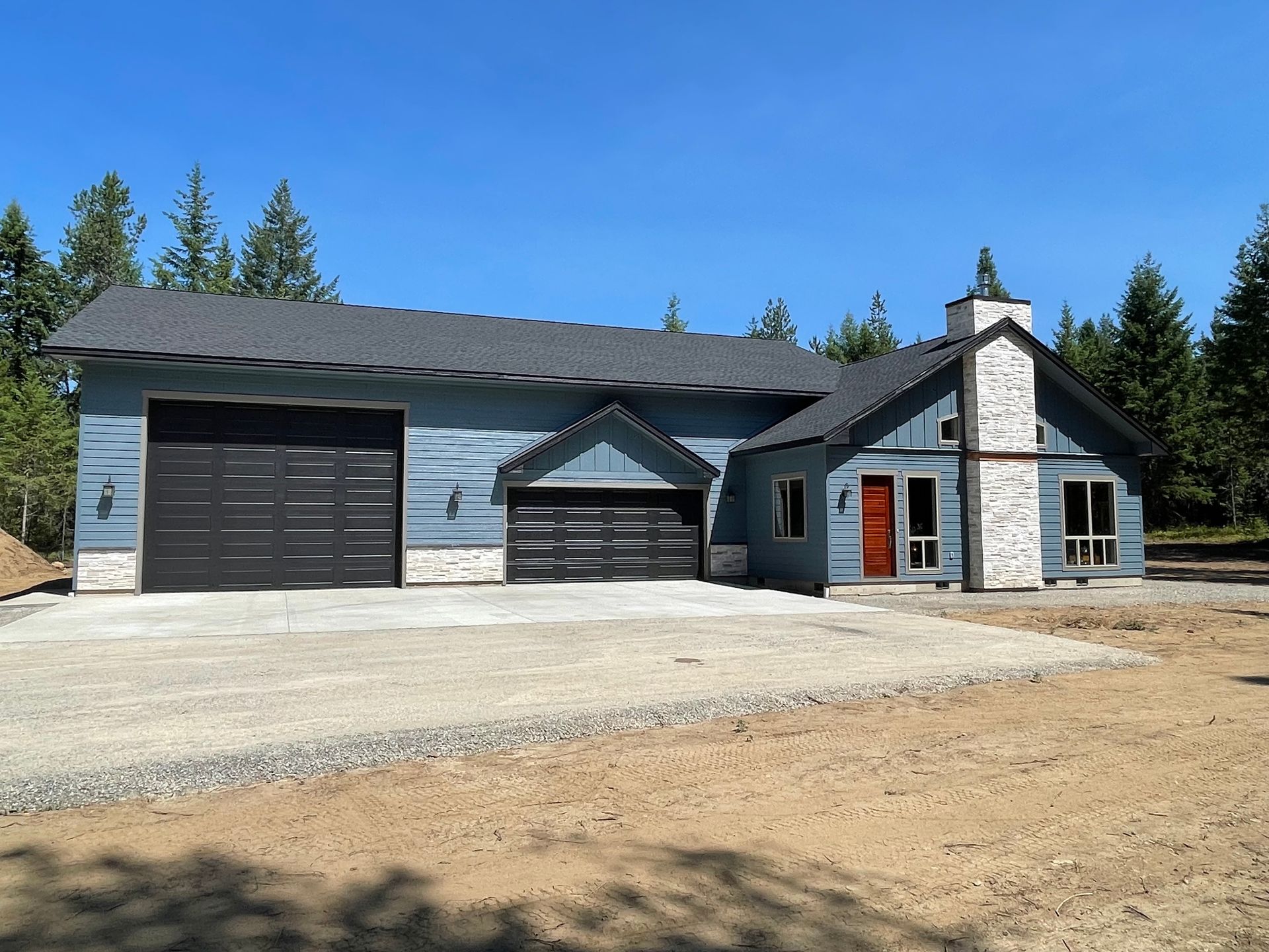 A large house with a garage and a chimney